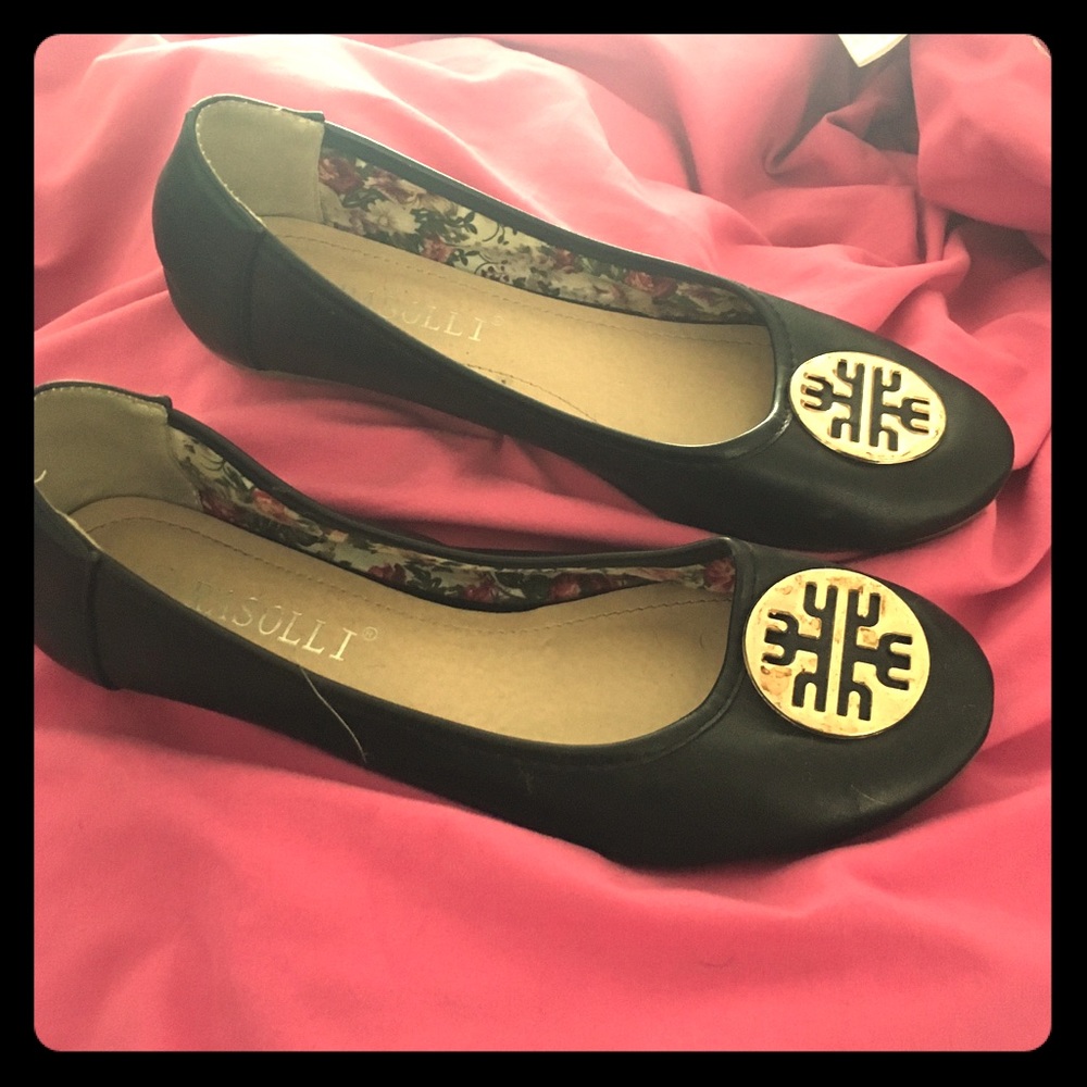 Black flats with gold medallion