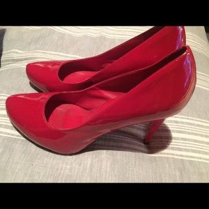 Gently worn red patent leather 4" pumps