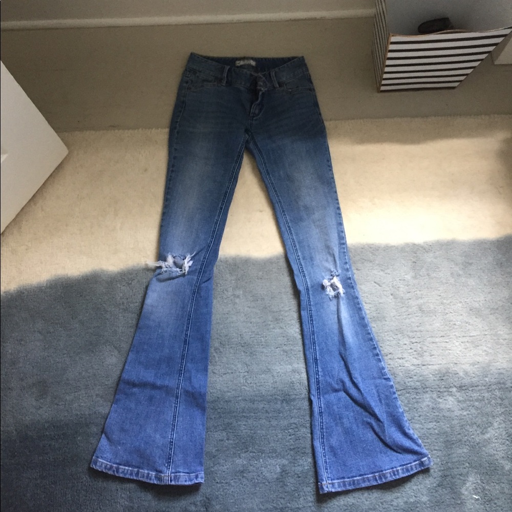 Ripped knee bellbottom blue jeans
