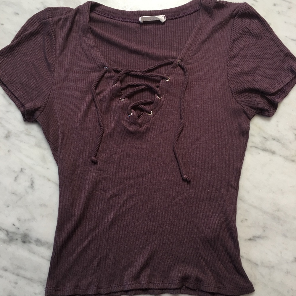 Purple tee with a interlaced tie at the neck.