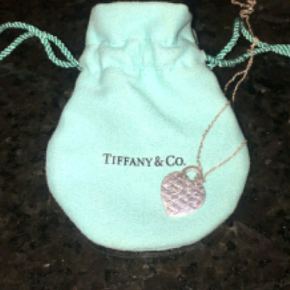 Heart necklace with cursive writing.