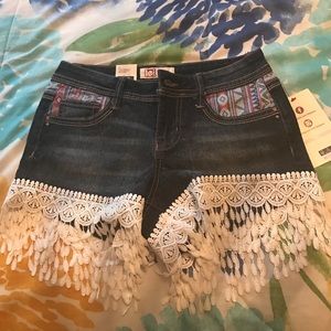 Lowrise dark washed fringe shorts