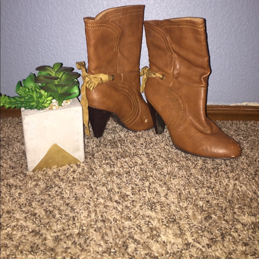 Cute brown boots with a tie in the back!