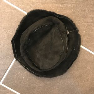 Black hat with leather trim.