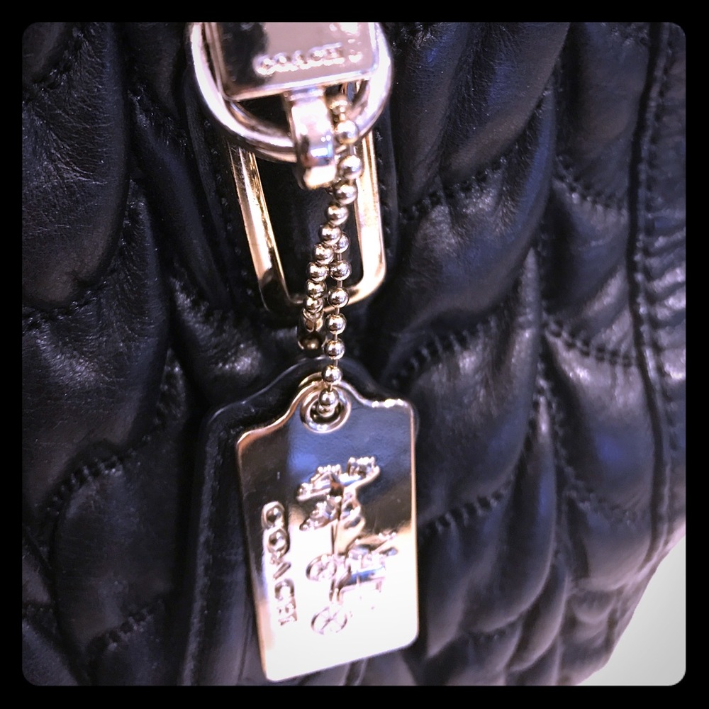 Coach black quilted style satchel type handbag.