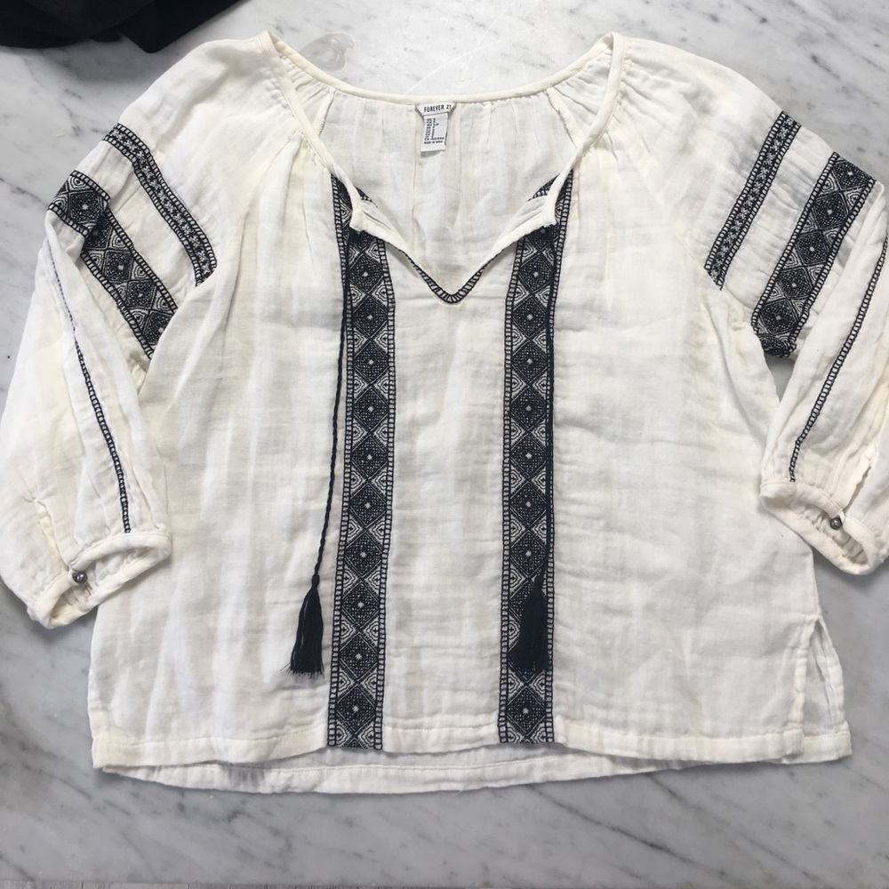 Long sleeve blouse with black detailing.