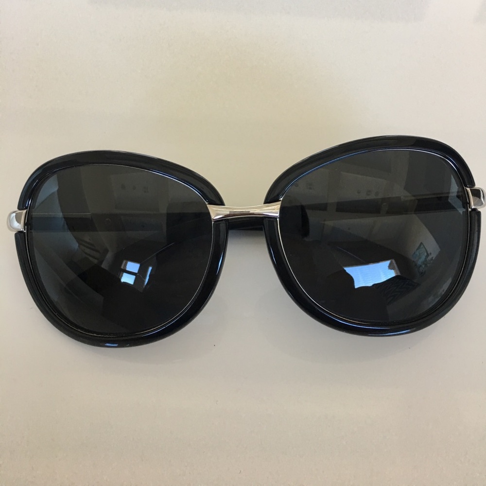 Prada sunglasses in black and silver hardware