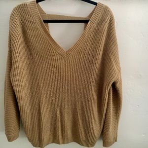 Beige sweater, deep back, and oversized.