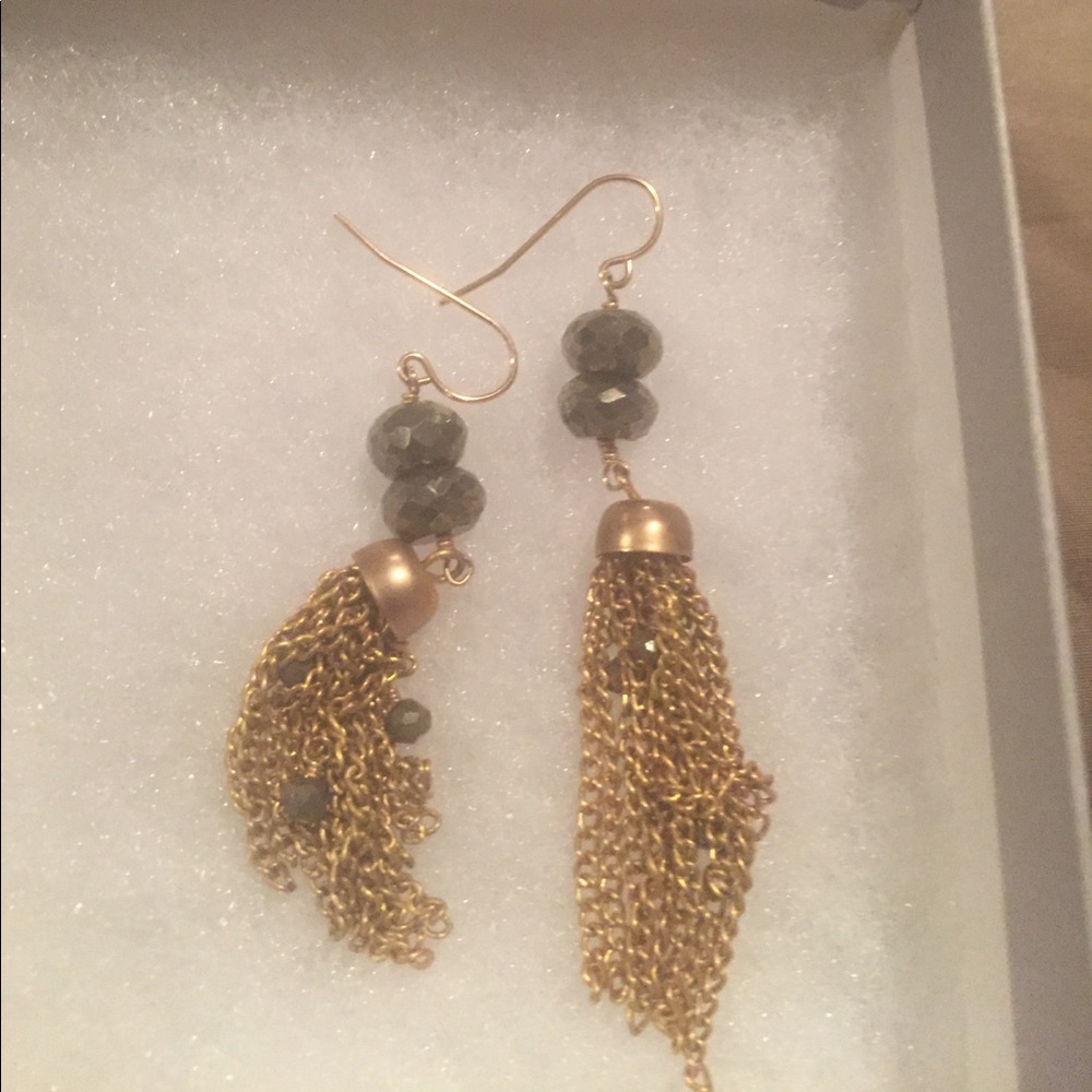 Gold earrings with black stones.