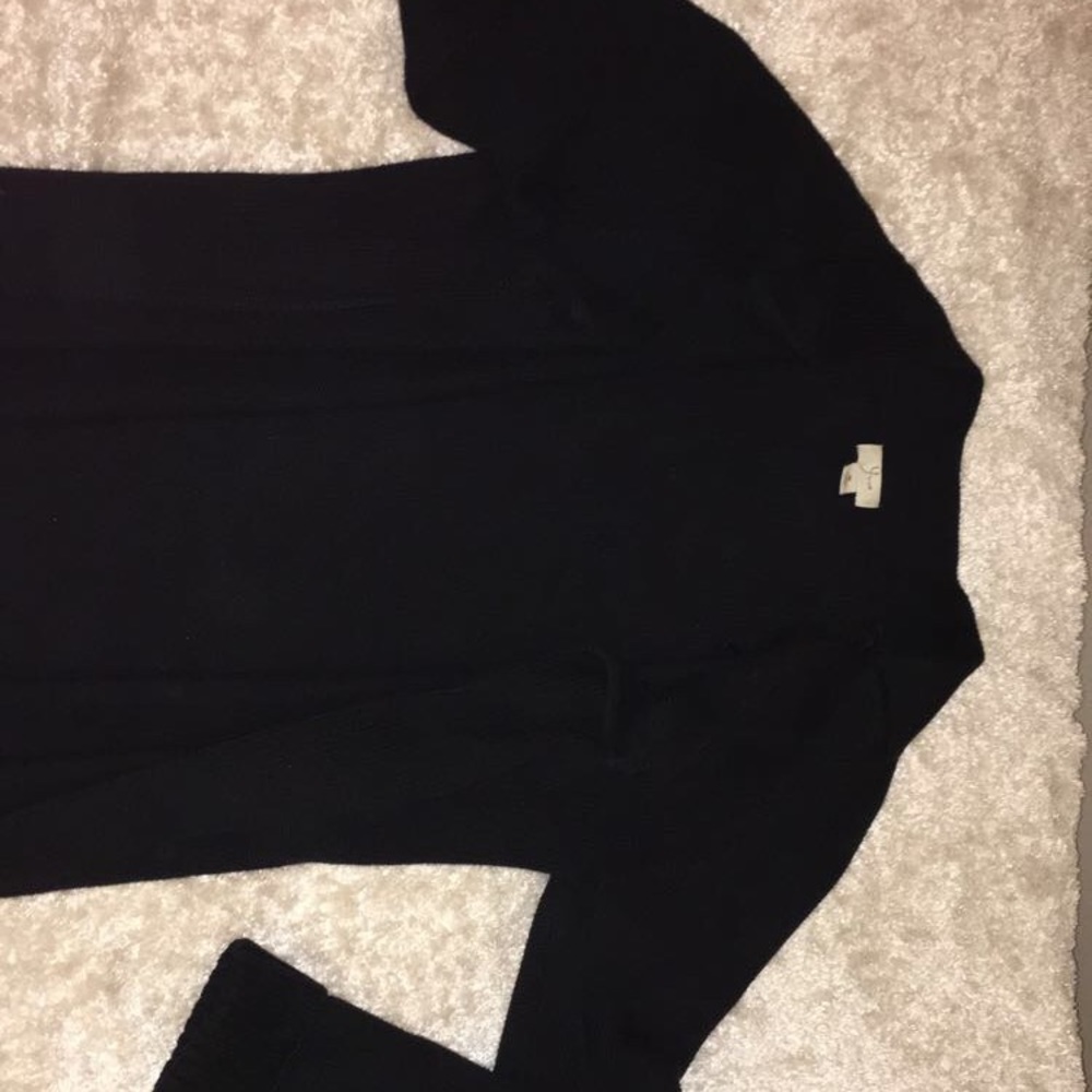 Black sweater. Up to waist.