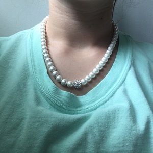 Pearl necklace with diamond covered ball at center