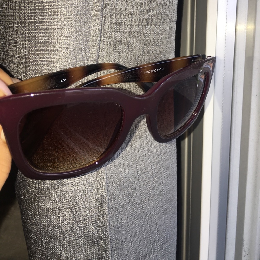 Dark burgundy sunglasses.
