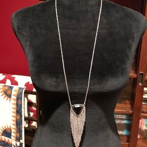 A faux onyx and has tassels.  Long drop.