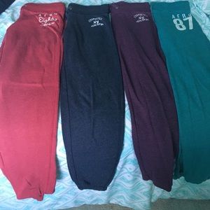4 pairs of sweatpants. Grey, red, purple,and green