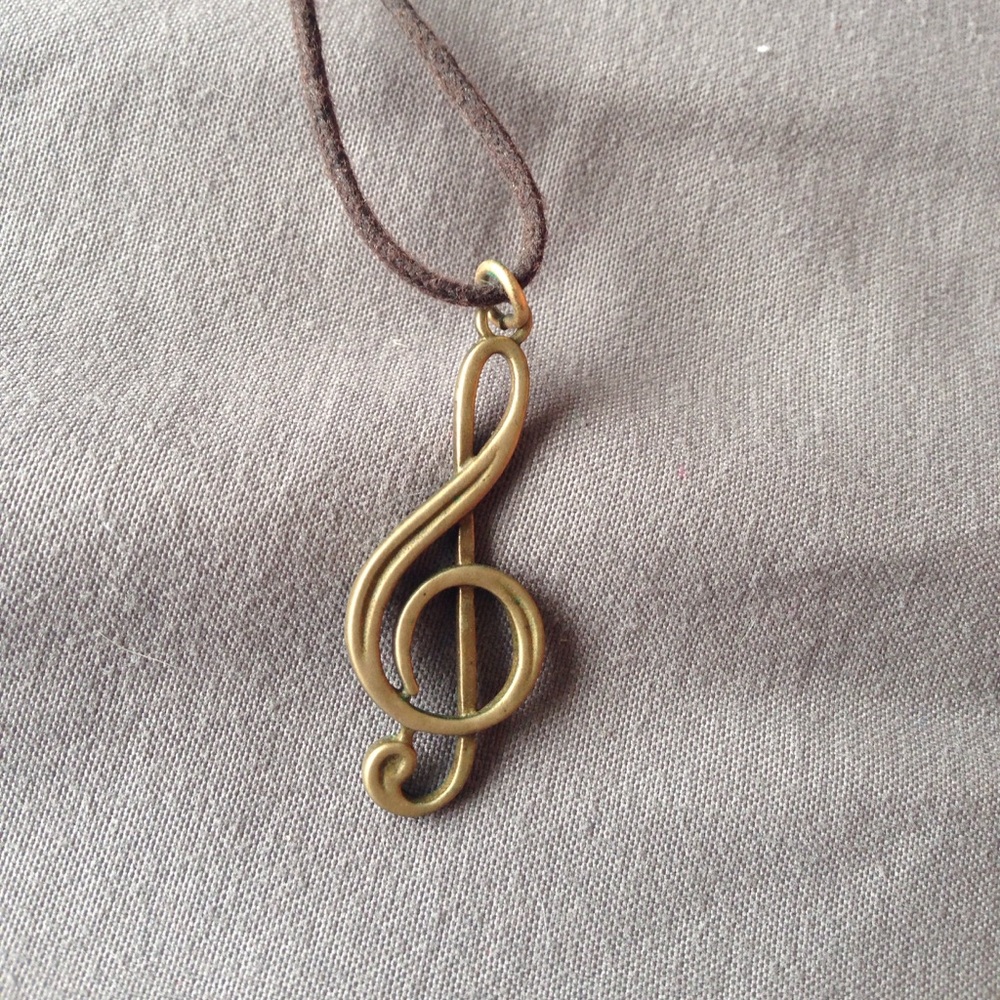 unique bronze necklace. Image of a treble clef.