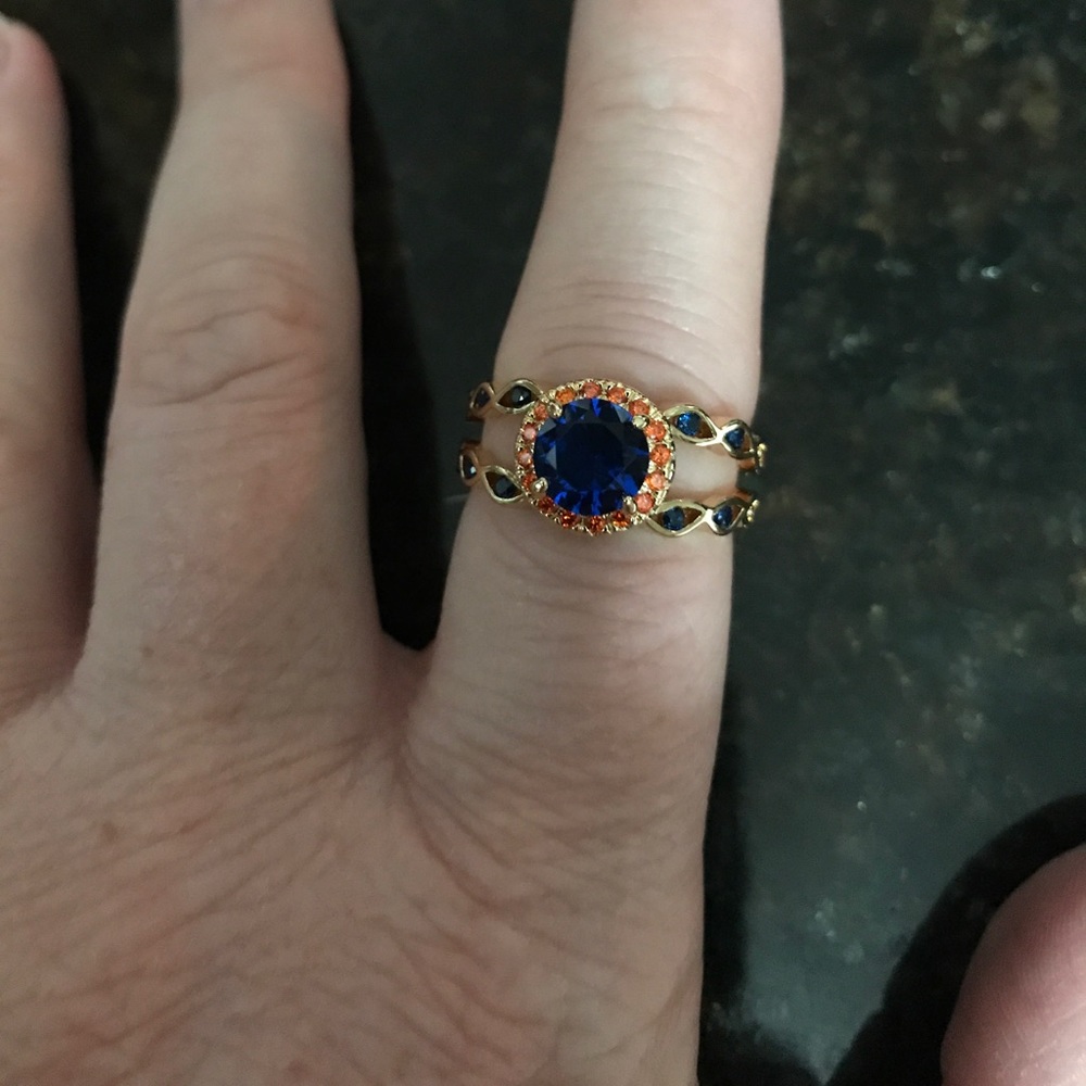 A ring with blue and orange stones. Size 8