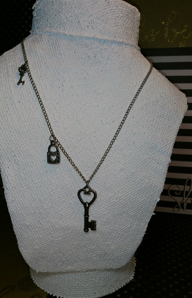 Antique silver necklace with keys and lock.