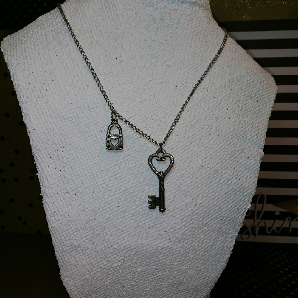 Antique silver necklace with key and lock.