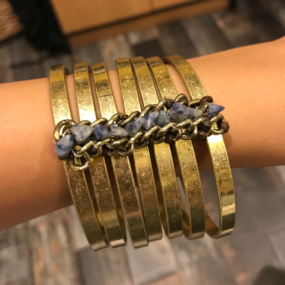 Gold linked bangles with blue stone details