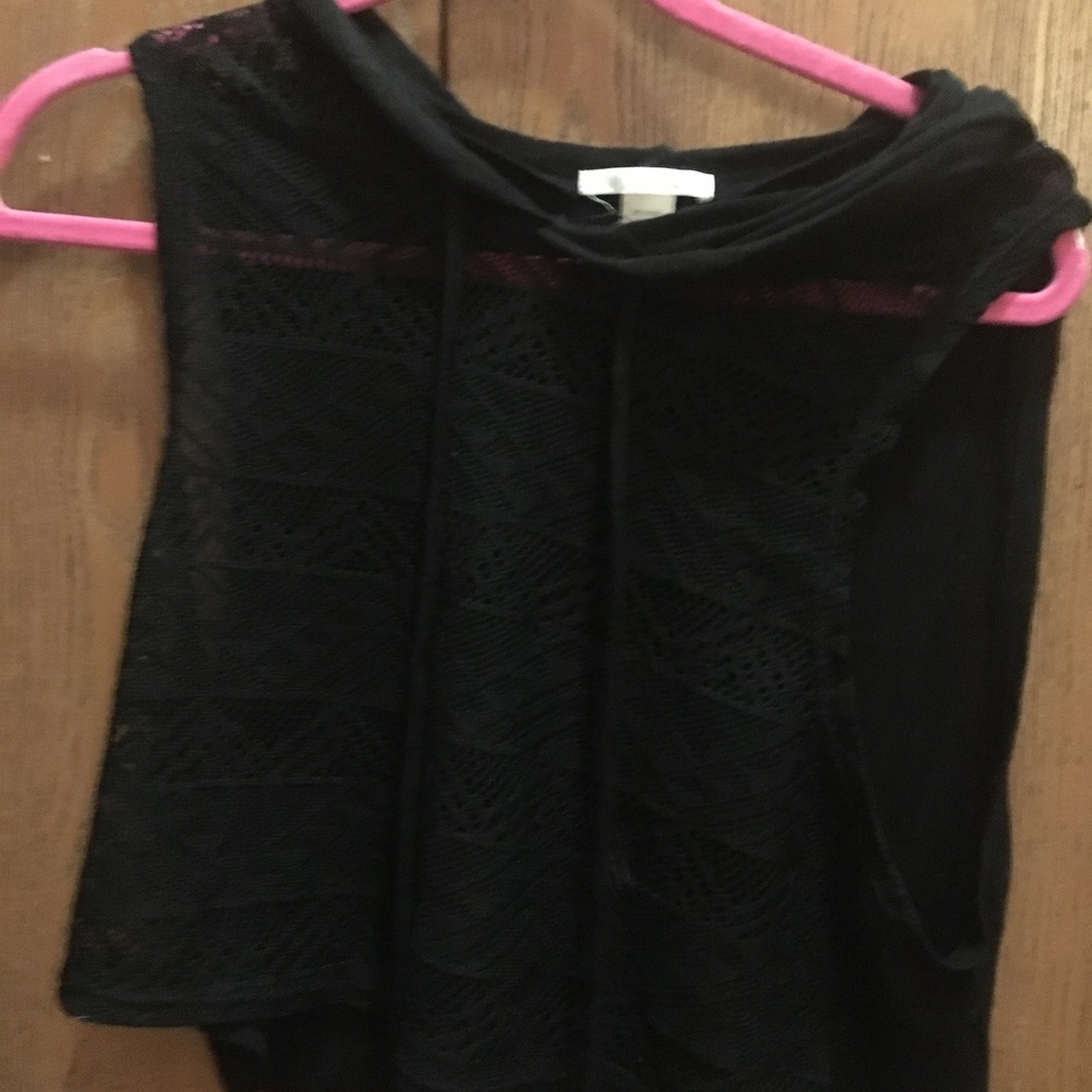 A mesh front shirt with a solid black back