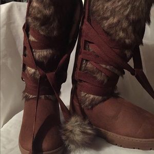 Faux fur man made knee high winter fashion boots.