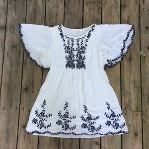 White flowy dress with blue embroidery