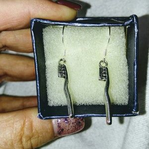 Handmade silver plated toothbrush earrings.