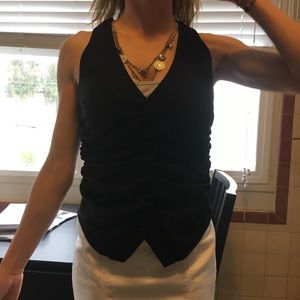 Black vest with ruching and buttons in front.