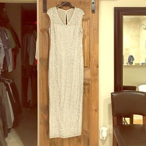 Silver gown with slit to knee on side.