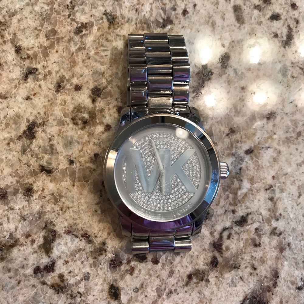 Silver oversized MK watch with rhinestone face.
