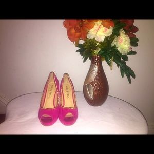 Pink shoes with gold trimming.