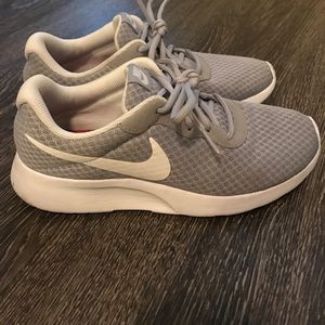 Grey and white Nike Tanjun shoes