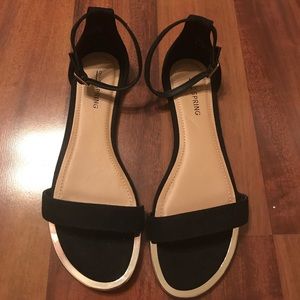 Black strappy sandals with gold detail