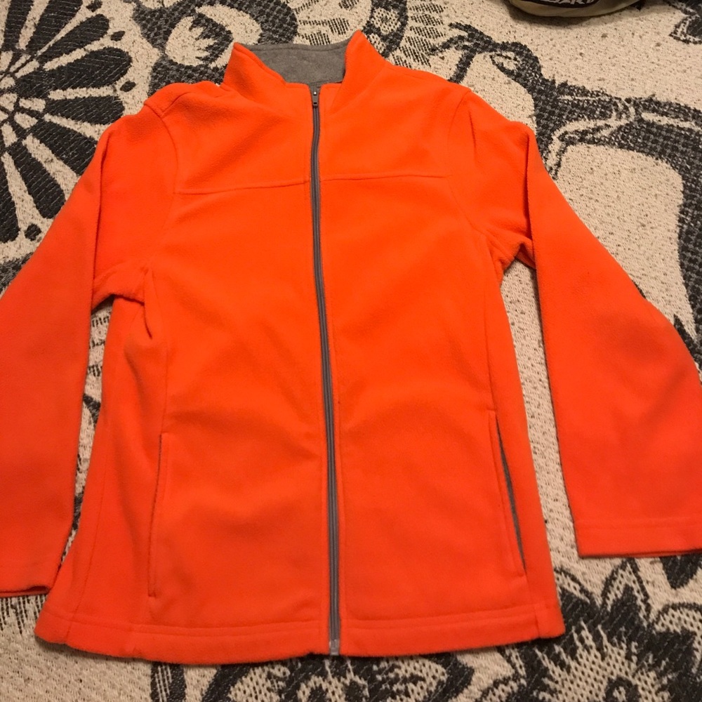 Orange zip up jacket.
