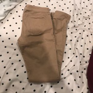 Tan Hollister skinny jeans.