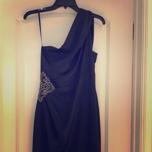 Dark blue satin dress with waist embellishments.