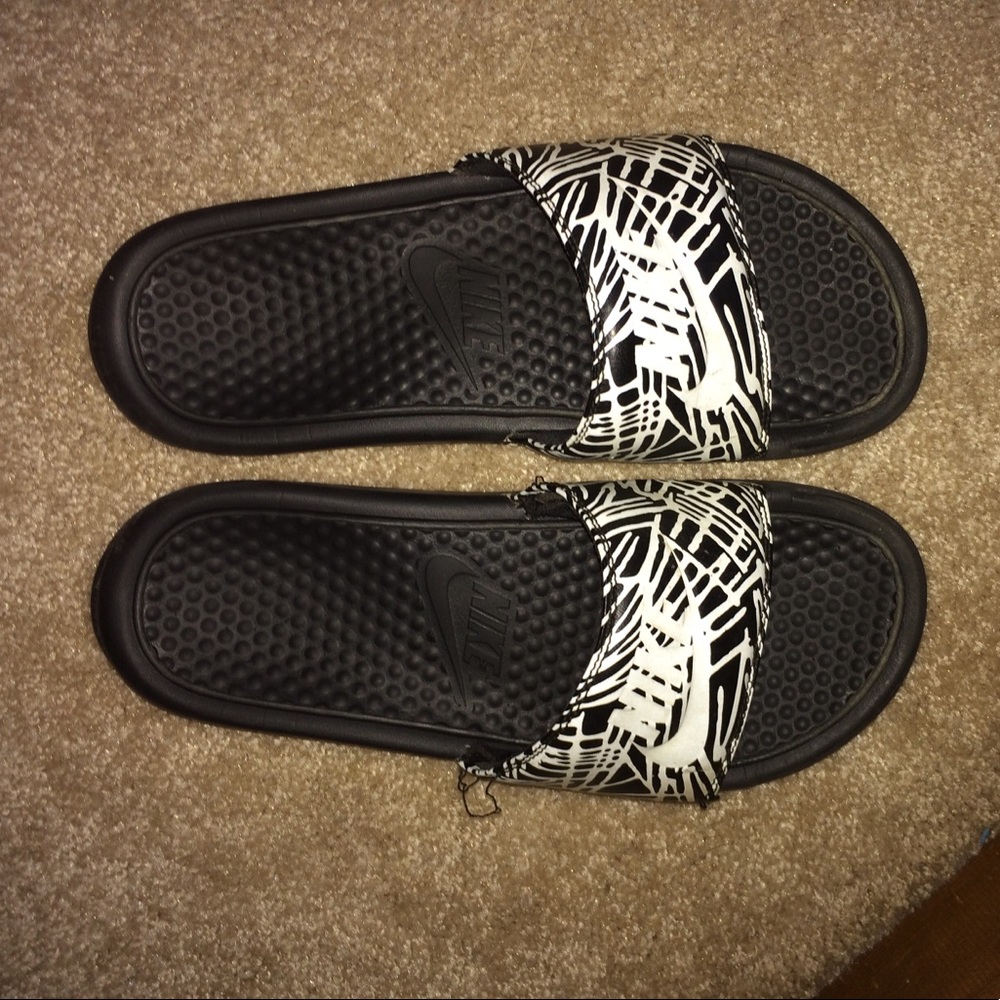 Black and white striped Nike slides