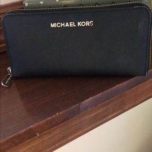 Black zip around Michael kor wallet