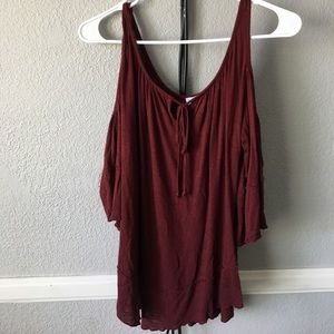 A maroon open shoulder top