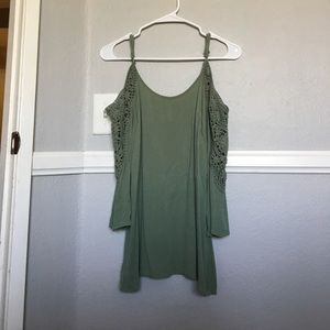 A green open shoulder shirt