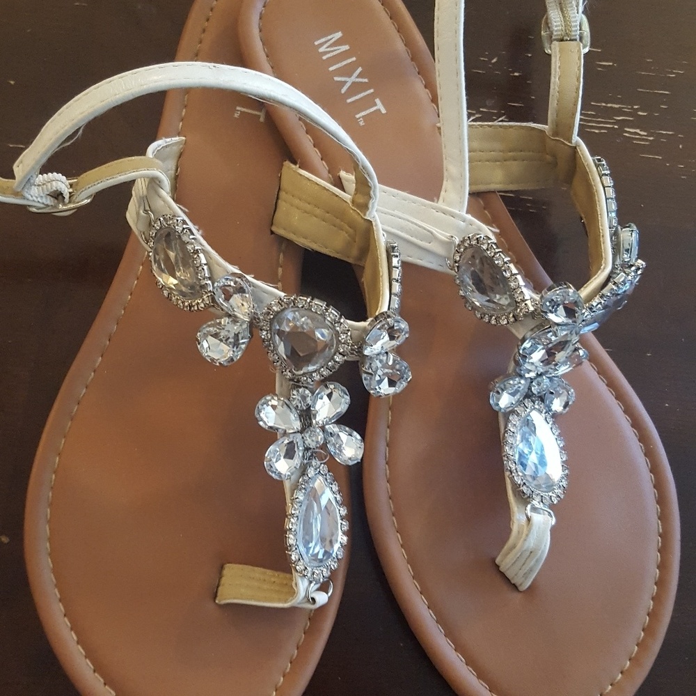 Bejeweled white sandals.