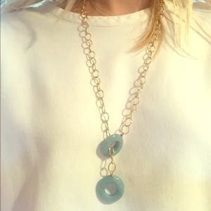Long gold necklace with jade rings