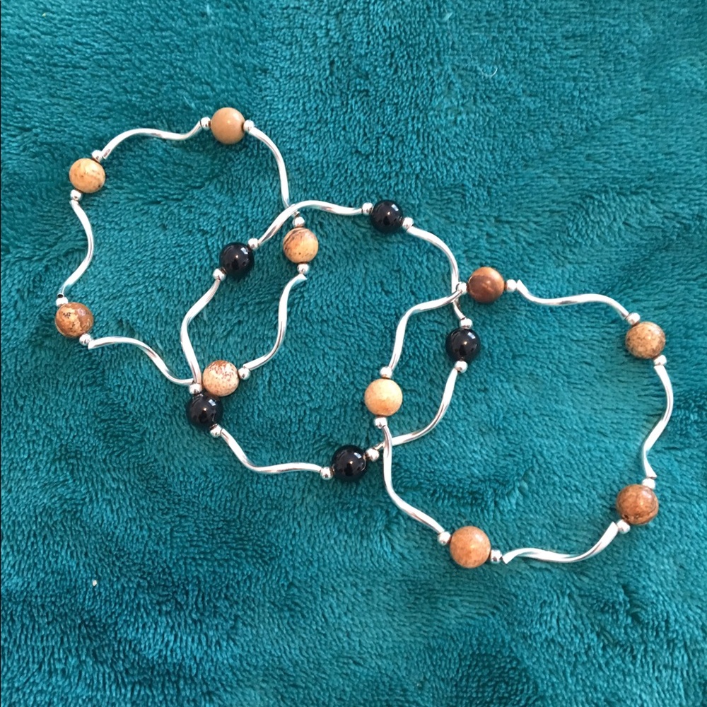 3 silver bracelets w/beads. Black/Brown/Tan.