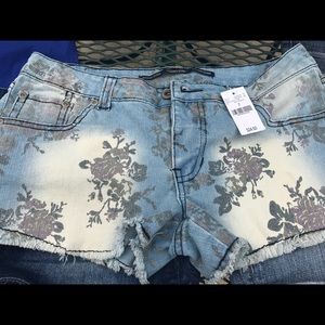Distressed floral print cutoffs