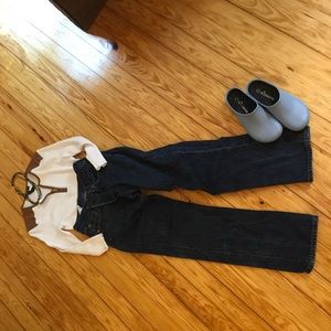 White, cotton, ribbed shirt with leather accents.