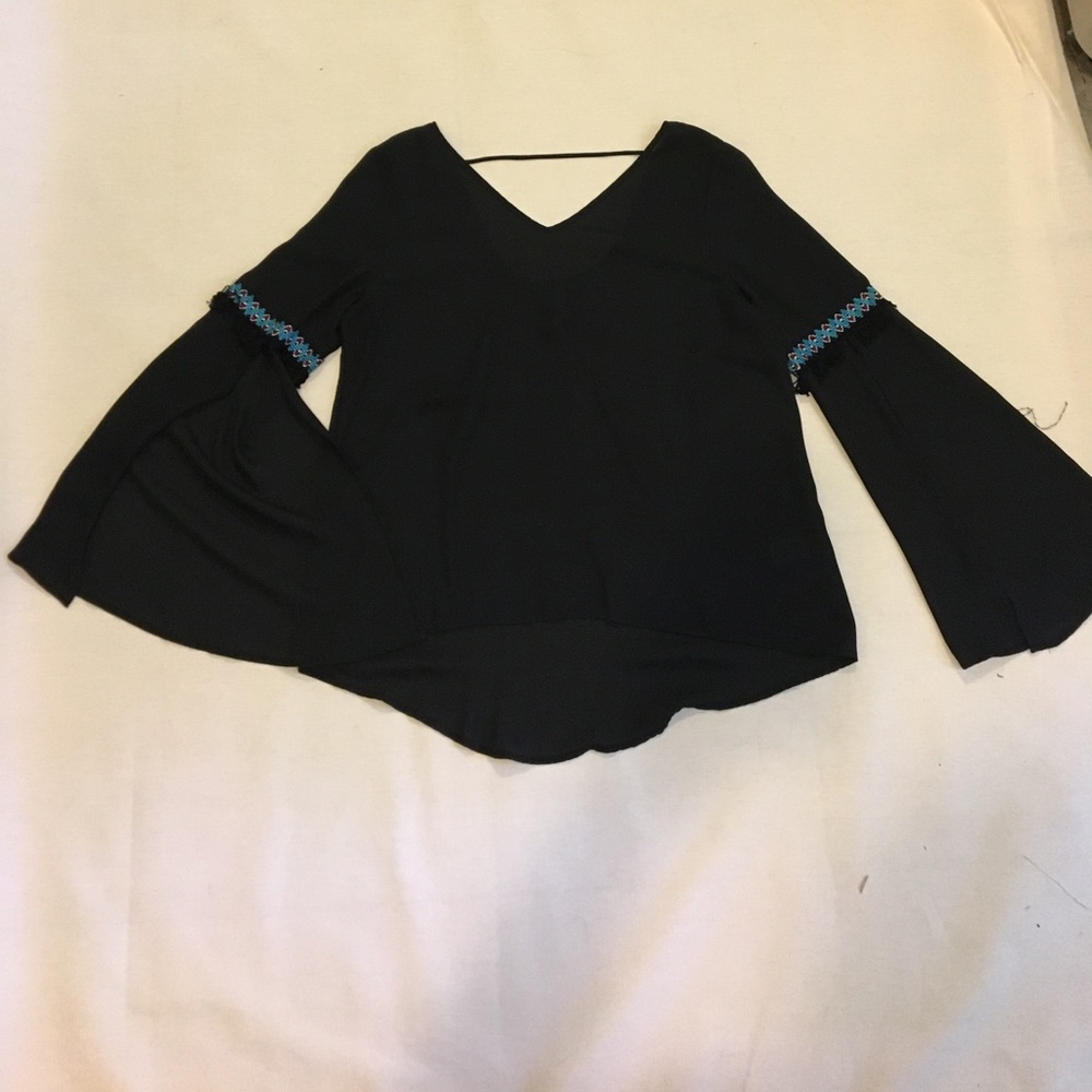 Large black bell sleeve with fringe accents