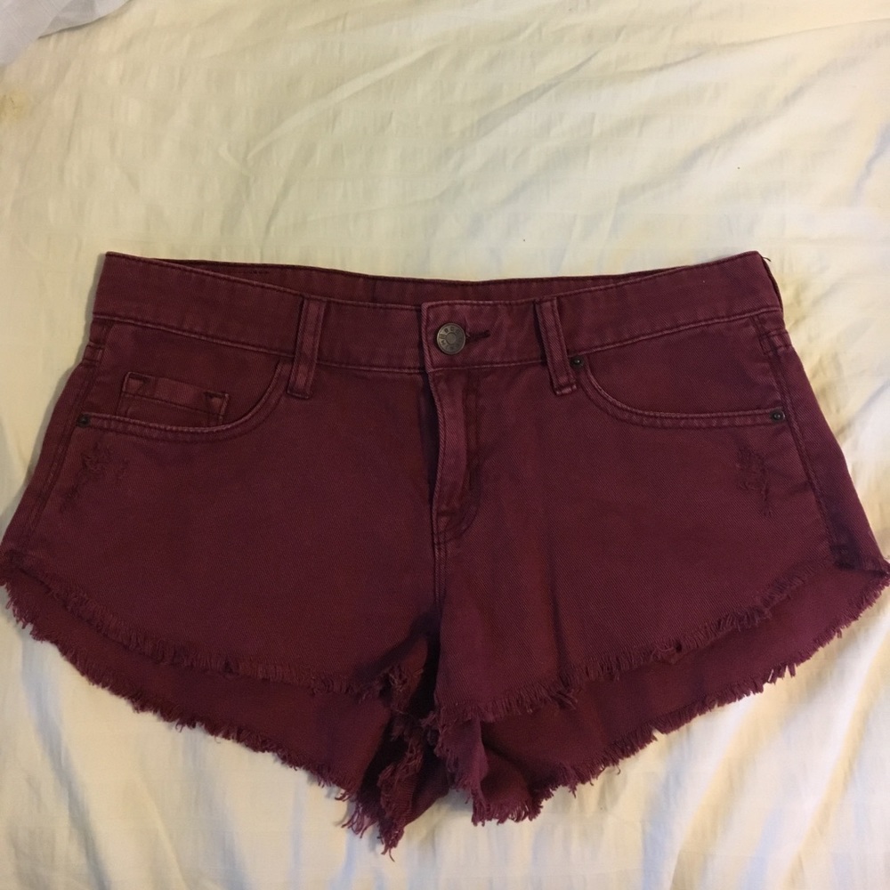 BDG low-rise dolphin distressed maroon shorts