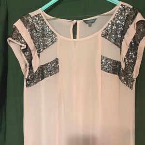 Pink with sequins and is 100% viscose