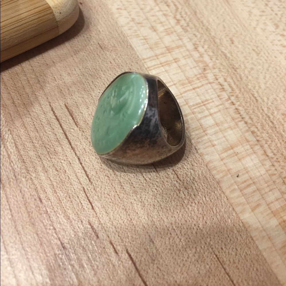 Silver ring with green stone.