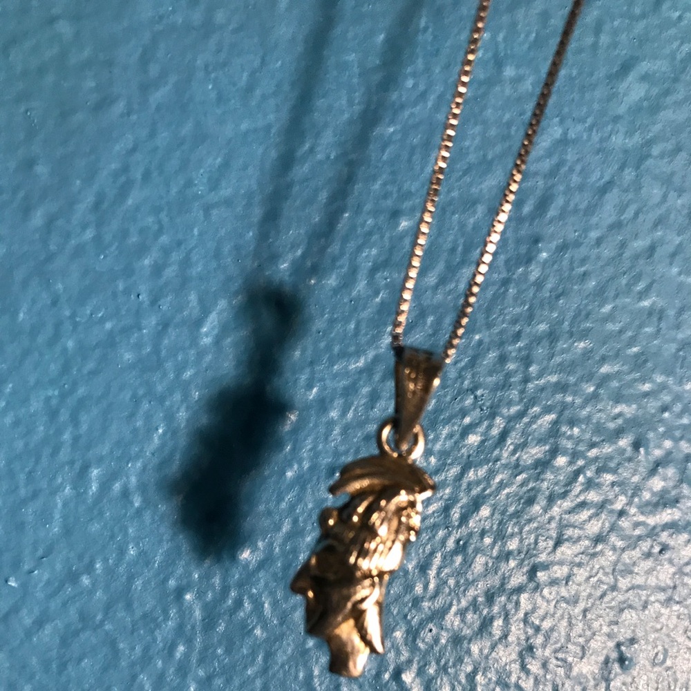 Indian man steering sliver necklace